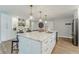 Bright kitchen with marble countertops, stainless steel appliances, and breakfast bar at 716 Palm Circle Dr, Port Orange, FL 32127