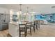 Open kitchen featuring an island with seating, and stainless steel appliances at 716 Palm Circle Dr, Port Orange, FL 32127