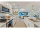 Beautiful, well-lit kitchen with stainless steel appliances and view to living room at 716 Palm Circle Dr, Port Orange, FL 32127