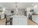 Spacious kitchen with a large center island featuring bar stool seating and modern lighting at 716 Palm Circle Dr, Port Orange, FL 32127