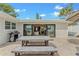 Outdoor patio with grill, dining table, and sliding doors leading to an indoor space at 716 Palm Circle Dr, Port Orange, FL 32127