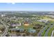 Community aerial shows sports fields, a community center, a pond, and local highways, set against a backdrop of residential homes at 741 Maderia Ct, Kissimmee, FL 34758