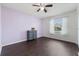 Bright bedroom with hardwood floors and a purple accent wall at 741 Maderia Ct, Kissimmee, FL 34758