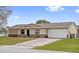 Lovely single-Gathering home featuring a two-car garage, a well-maintained lawn and driveway at 741 Maderia Ct, Kissimmee, FL 34758