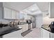 Bright and airy kitchen featuring white cabinets, stainless steel appliances, and modern countertops at 741 Maderia Ct, Kissimmee, FL 34758