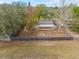 Aerial shot showcases a home with a large, fenced backyard and mature trees at 7730 Pineapple Dr, Orlando, FL 32835