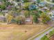 Aerial view of homes with spacious, fenced backyards amidst lush greenery in a residential neighborhood at 7730 Pineapple Dr, Orlando, FL 32835