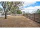 Expansive, fenced backyard with mature trees offering privacy and room for recreation at 7730 Pineapple Dr, Orlando, FL 32835