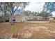 Large backyard with a grill, screened-in porch, and garden, offering great outdoor living at 7730 Pineapple Dr, Orlando, FL 32835