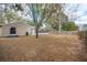 Spacious backyard featuring a grill, screened-in porch, mature trees and privacy fence at 7730 Pineapple Dr, Orlando, FL 32835