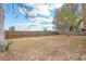 Large fenced backyard with mature trees, providing ample space for outdoor activities at 7730 Pineapple Dr, Orlando, FL 32835