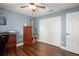 Bedroom features wood floors, a ceiling fan, and closet space with ample storage at 7730 Pineapple Dr, Orlando, FL 32835