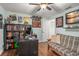 Bedroom office with a futon, computer, ceiling fan, laminate wood floors, and unique decor at 7730 Pineapple Dr, Orlando, FL 32835