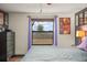 Cozy bedroom featuring natural light from a large window, complemented by hardwood floors and stylish decor at 7730 Pineapple Dr, Orlando, FL 32835