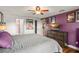 Comfortable bedroom with a ceiling fan, hardwood floors, and ample space for relaxation and entertainment at 7730 Pineapple Dr, Orlando, FL 32835