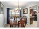Inviting dining room with a view to a covered patio, stylish lighting, and easy kitchen access at 7730 Pineapple Dr, Orlando, FL 32835