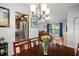 Cozy dining room featuring a chandelier, dining table, and natural light at 7730 Pineapple Dr, Orlando, FL 32835