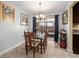 Bright dining room with stylish lighting, a view to a covered patio, and a table for four at 7730 Pineapple Dr, Orlando, FL 32835