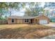 Inviting single-story home with a well-manicured lawn, attached garage, and lovely facade at 7730 Pineapple Dr, Orlando, FL 32835