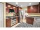 Modern kitchen features granite countertops, stainless steel appliances, and dark wood cabinets at 7730 Pineapple Dr, Orlando, FL 32835