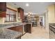 Well-lit kitchen featuring granite counters, stainless steel appliances and easy access to dining at 7730 Pineapple Dr, Orlando, FL 32835