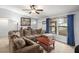 Comfortable living room featuring a large sectional sofa, ceiling fan, and natural light at 7730 Pineapple Dr, Orlando, FL 32835