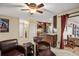 Spacious living room featuring a cozy seating area and an open layout, seamlessly connected to the kitchen at 7730 Pineapple Dr, Orlando, FL 32835