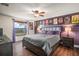 Bedroom with a large comfortable bed, hardwood floors and large window for light at 7730 Pineapple Dr, Orlando, FL 32835