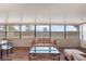 Inviting sunroom featuring a comfortable couch, large windows, and a dining area at 7730 Pineapple Dr, Orlando, FL 32835