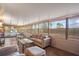 Bright and airy sunroom with a cozy seating arrangement, large windows, and serene views at 7730 Pineapple Dr, Orlando, FL 32835