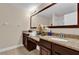 Bathroom boasts double vanity sinks with granite countertops and a large mirror at 8201 Roseville Rd, Davenport, FL 33896