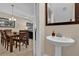 Bathroom includes a sleek pedestal sink, framed mirror, and tasteful decor at 8201 Roseville Rd, Davenport, FL 33896