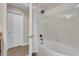 Bright bathroom featuring a shower-tub combo, white tiles, and modern fixtures at 8201 Roseville Rd, Davenport, FL 33896