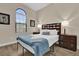 Bright bedroom with wooden floors, stylish headboard and natural light from the window at 8201 Roseville Rd, Davenport, FL 33896
