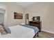 Cozy bedroom features a comfortable bed and dresser with artwork on the wall at 8201 Roseville Rd, Davenport, FL 33896