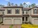 Charming townhome featuring a tile roof, well-maintained landscaping, and inviting curb appeal at 8201 Roseville Rd, Davenport, FL 33896