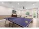 Recreation room with a table tennis setup, plus a comfortable seating area and television at 8201 Roseville Rd, Davenport, FL 33896