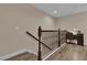 Hallway with wooden floors and staircase with decorative metal railings at 8201 Roseville Rd, Davenport, FL 33896