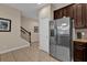 Hallway view features stainless steel refrigerator and staircase at 8201 Roseville Rd, Davenport, FL 33896