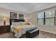 Comfortable bedroom with a plush bed, side tables, and natural light streaming through the window at 8201 Roseville Rd, Davenport, FL 33896