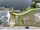 Aerial view of a vacant lot with lake access, outlined in yellow and ready for development at 8517 Karrer Ter, Orlando, FL 32827