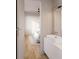 Bathroom view with white vanity, modern sink, and wood-look floors leading to the bedroom at 8517 Karrer Ter, Orlando, FL 32827