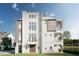Stunning three-story home boasting large windows and a waterside view at 8517 Karrer Ter, Orlando, FL 32827