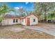 Exterior angle of a home with a concrete drive and compact yard, under a blue sky at 1014 24Th St, Orlando, FL 32805