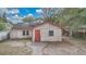 Exterior shot of the home from its backyard with a red door and white paint at 1014 24Th St, Orlando, FL 32805