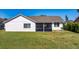 Back exterior view with screened-in lanai and outdoor kitchen at 12137 Dickenson Ln, Orlando, FL 32821