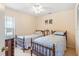 Comfortable bedroom with two beds and a ceiling fan at 12137 Dickenson Ln, Orlando, FL 32821