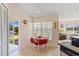 Sunlit breakfast nook featuring a window with backyard views and access to the porch at 12137 Dickenson Ln, Orlando, FL 32821