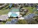 Aerial view of community pool, tennis court, playground, and parking area with a view of pond at 12137 Dickenson Ln, Orlando, FL 32821