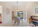 Cozy dining area featuring a glass table, chandelier, and view of the outside at 12137 Dickenson Ln, Orlando, FL 32821